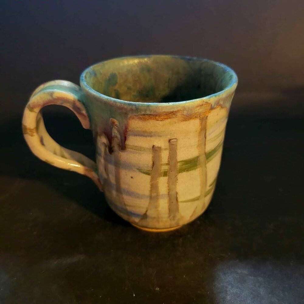 Handmade Ceramic Mug With a Striped Glaze Pattern And An Organic, Drippy Glaze
